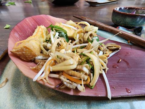       Plated vegetable dish with sprouts and tofu.
  