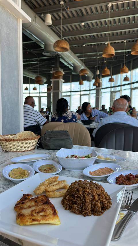 Indoor restaurant scene with patrons seated at tables.