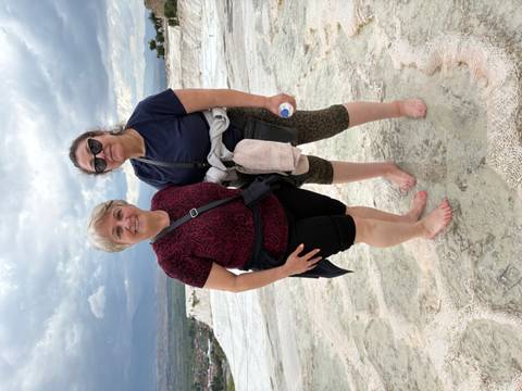 Two women standing on the travertine terraces of Pamukkale.