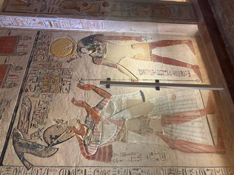 Close-up of ancient Egyptian wall carvings with hieroglyphics.