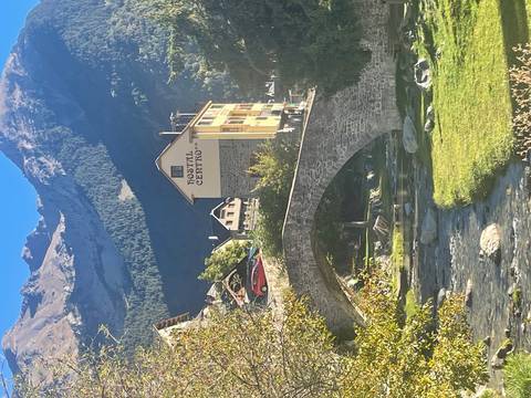 Mountain village with a bridge over a stream.