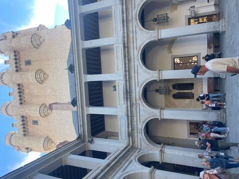 Courtyard of a historic castle with tourists.