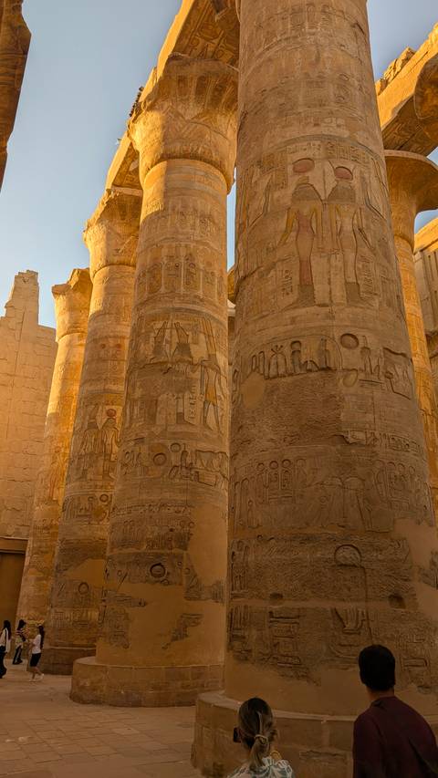 Columns with detailed carvings in an Egyptian temple.