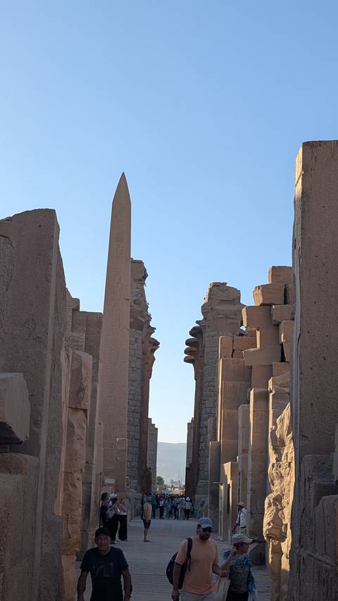 View of an ancient Egyptian obelisk and ruins.