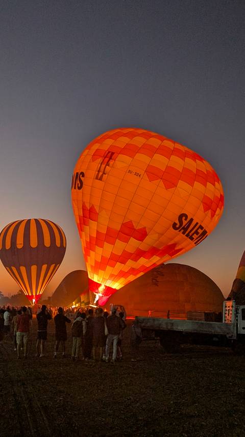 Hot air balloons rising during a clear sunrise or sunset.