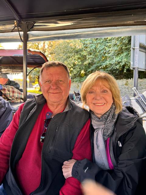       Couple smiling on a carriage ride.
  