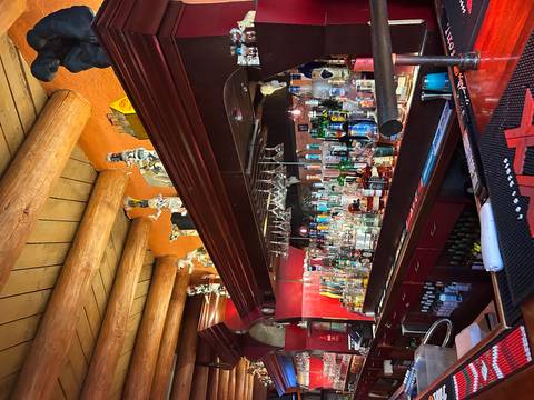 Interior of a bar with various bottles and decorations.