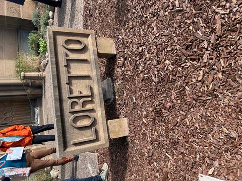 Loretto Chapel entrance with visible stone sign.