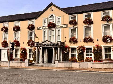       A hotel building with florally decorated windows and a classic facade.
  