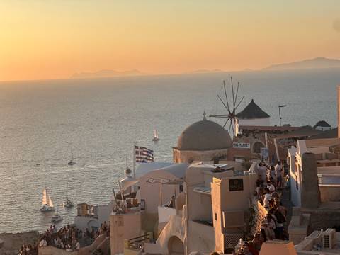       A scenic view of Oia, Santorini at sunset with windmills
  