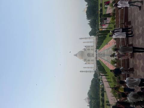 People walking in front of the Taj Mahal.
