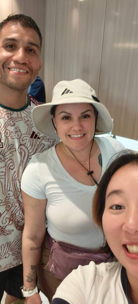       A woman smiling inside an indoor setting.
  