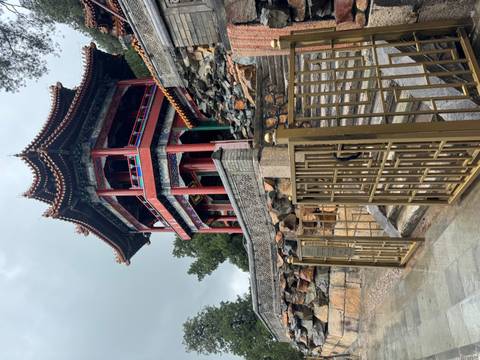       A traditional Chinese pavilion on a stone platform.
  