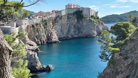 Scenic view of Dubrovnik's old city walls and coastline.