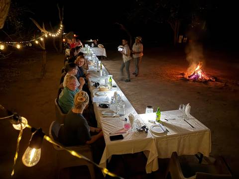 Outdoor dinner setting with a bonfire.