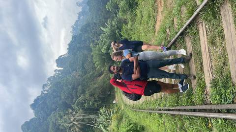 A group standing on a train track amidst lush greenery.