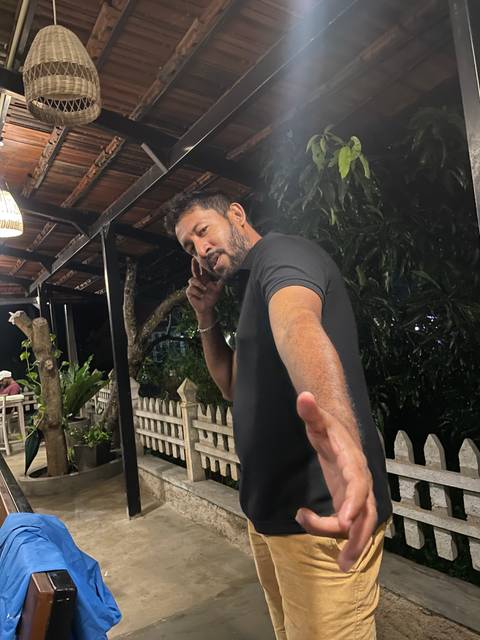 A person posing for a photo at night.