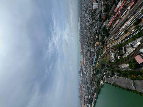       Aerial view of a city with a harbor and infrastructure.
  