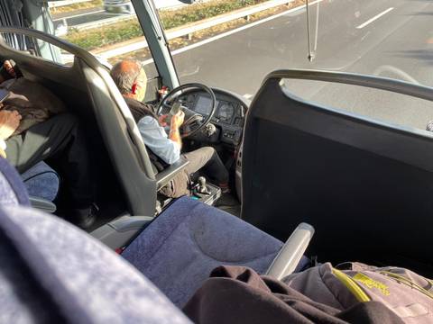 Bus interior with driver and passengers.