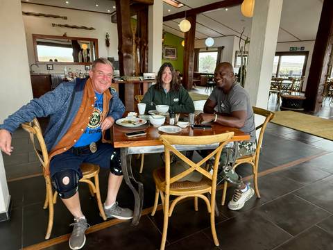       Three people dining at a restaurant.
  