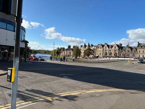 Bridge over a river with cityscape in the background.