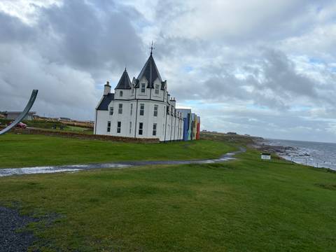       White castle-like building by the sea.
  