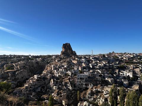 Rocky hilltop city with unique rock formations.