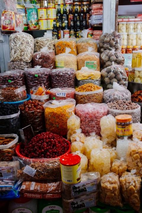 Market stall with bags of dried goods and spices.