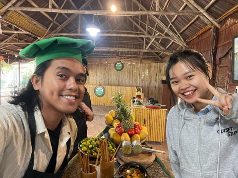       Selfie of two smiling people in a market stall
  