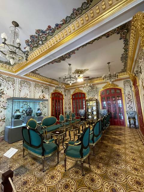 Ornately decorated room with elegant furniture and chandeliers