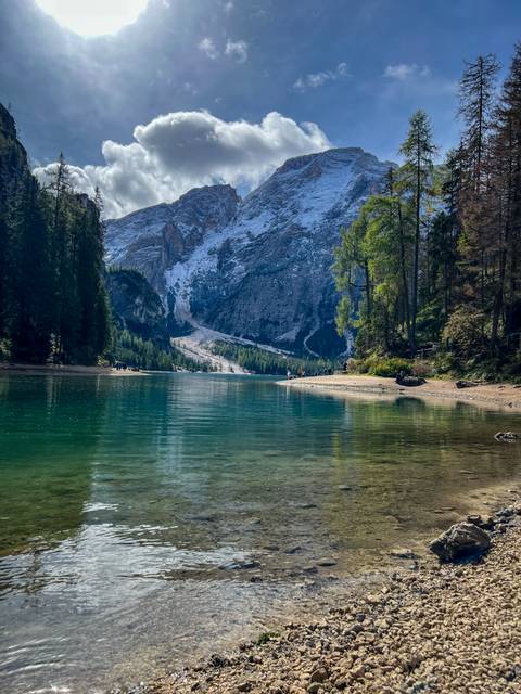 Scenic lake surrounded by mountains and trees.