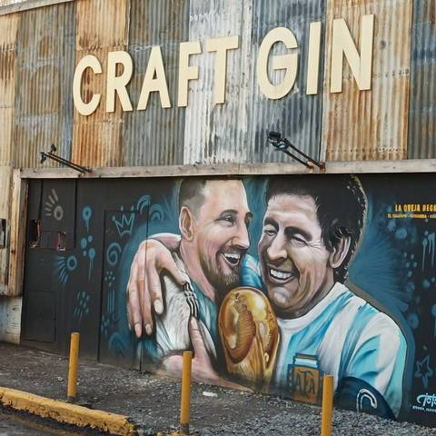 Colorful street art mural depicting famous personalities.