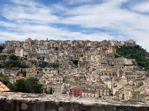 Historic hillside town with numerous stone buildings.