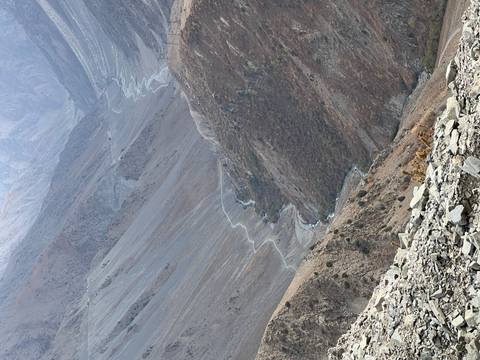       A panoramic view of a desert valley with winding paths.
  