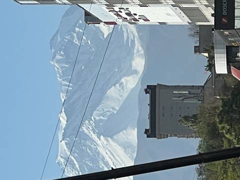       A cityscape with a mountain backdrop.
  