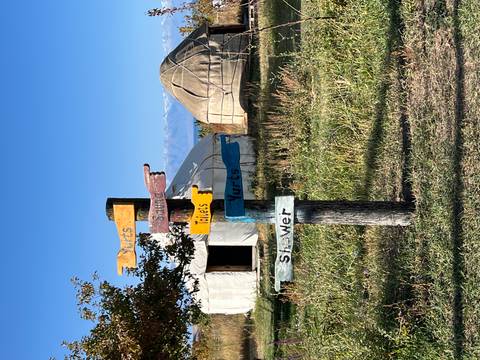       Yurts with directional signs in front.
  