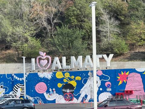 Colorful mural in Almaty with text 'I love Almaty'.