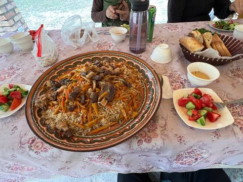       A dish of rice with vegetables and meat, served with salads.
  