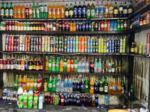       Display of various bottled drinks on shelves.
  