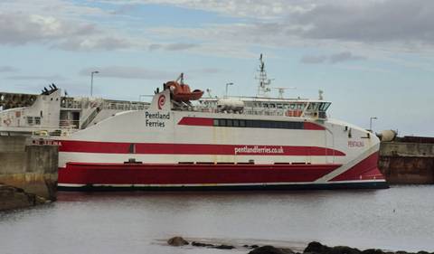       Ferry docked at a port with a visible logo.
  