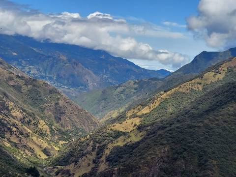 Scenic view of green Ecuadorian mountain landscape under cloudy sky.