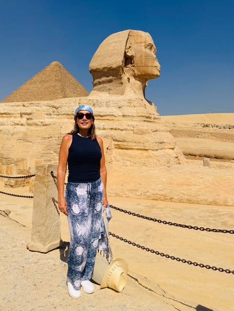 Person posing near the Sphinx in Giza.