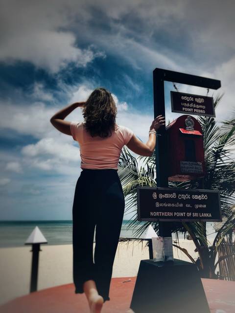 Person standing by a sign at Point Pedro, Northern Sri Lanka.