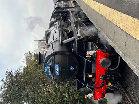 Jacobite steam train on tracks, known for scenic routes.