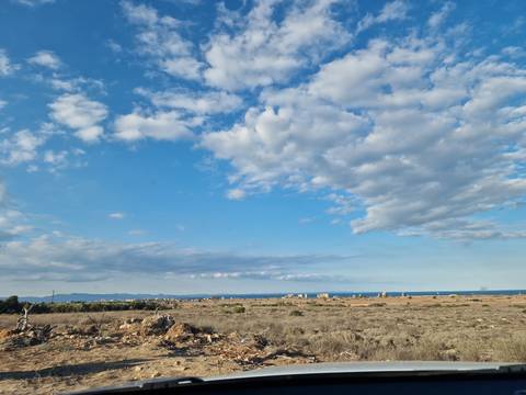 Wide landscape of fields and clouds.