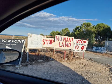 Signs indicating military zone at a viewpoint.