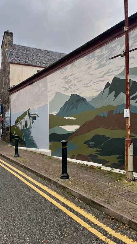 Colorful wall mural with nature scene.