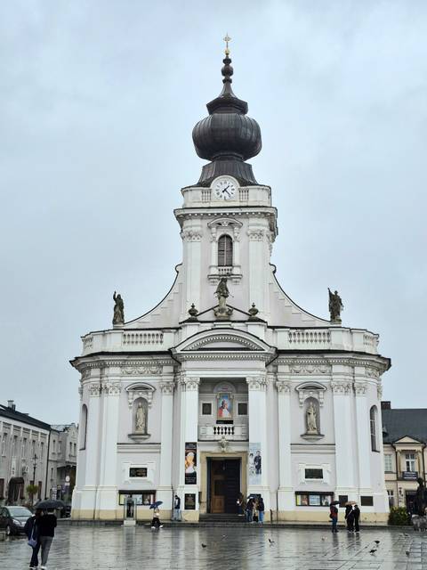 Detailed white facade of a historic building with clock.