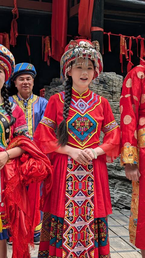       People in colorful traditional costumes.
  