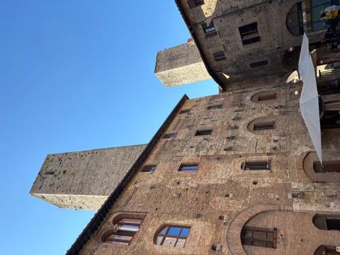 Historic stone towers and buildings in a town square.